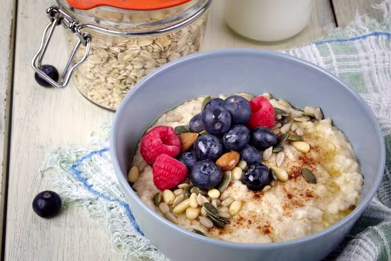 Oatmeal topped with a vibrant mix of berries, nuts, and seeds